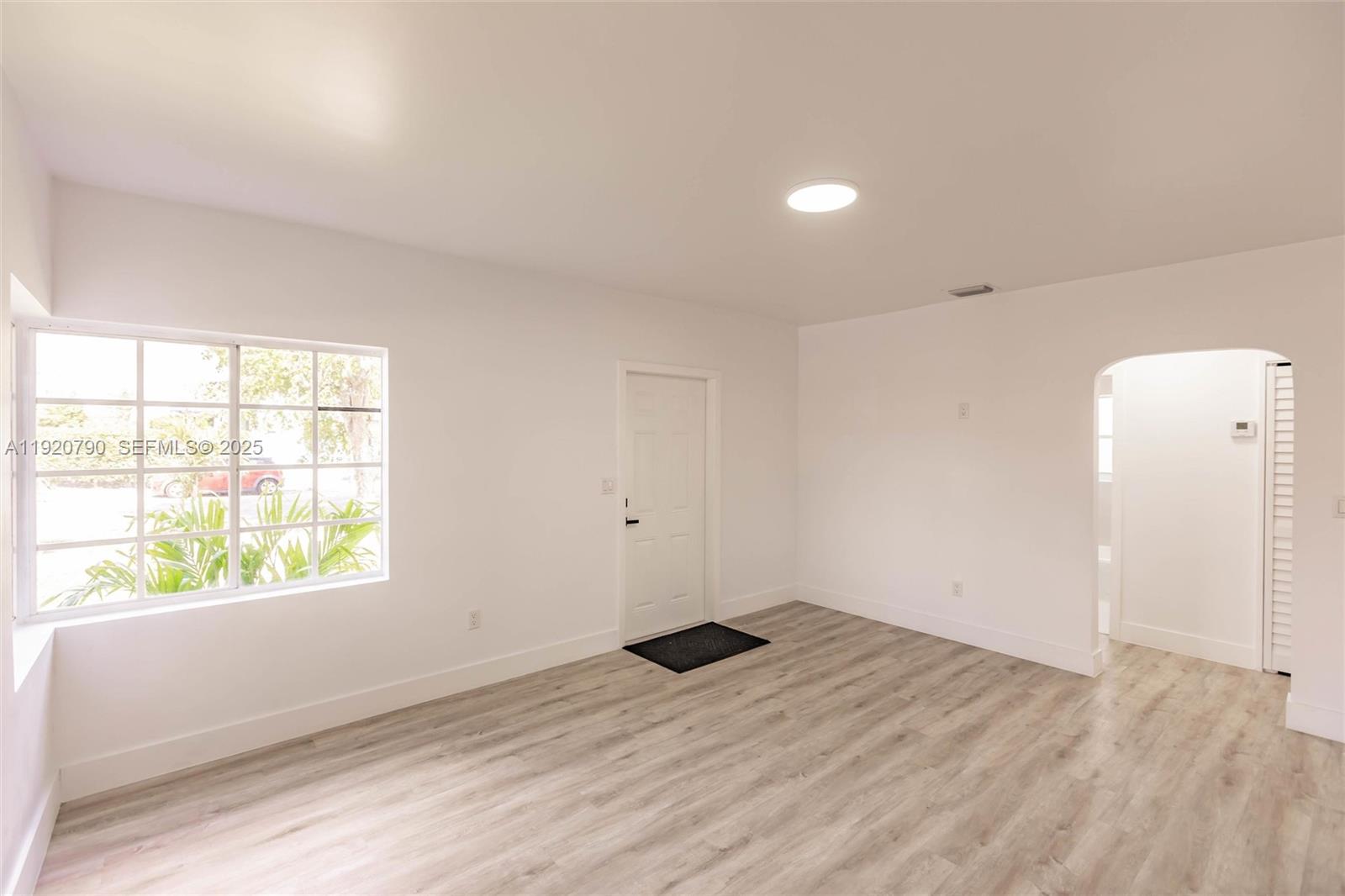 3180 Northwest 2nd Street Miami, FL 33125 - Photo 7 of 29 an empty room with wooden floor and windows