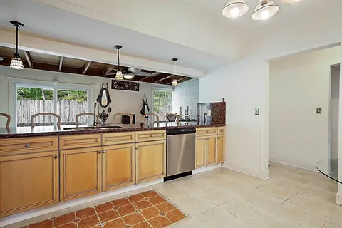 a kitchen with stainless steel appliances a stove a sink and a microwave