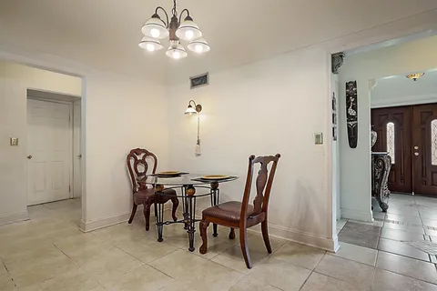 a view of hallway with a mirror and a rug