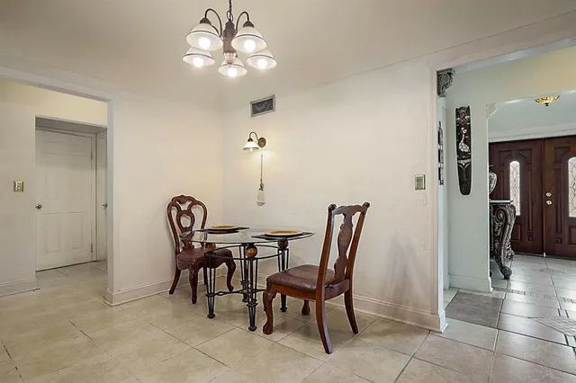 a view of hallway with a mirror and a rug