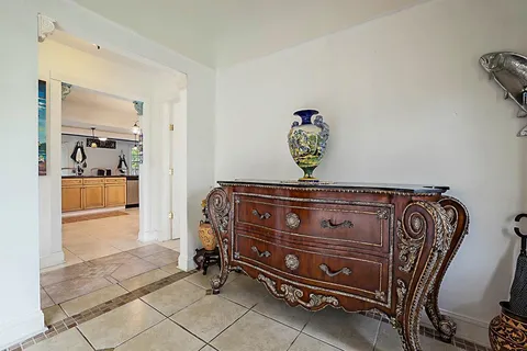 a view of a dining room with furniture a chandelier and window