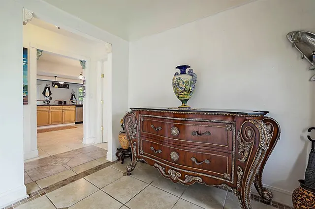 a view of a dining room with furniture a chandelier and window