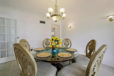 a bed room with a bed and a chandelier