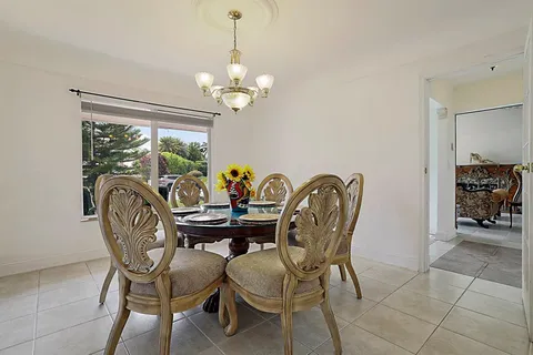 a bed sitting in a bedroom and chair