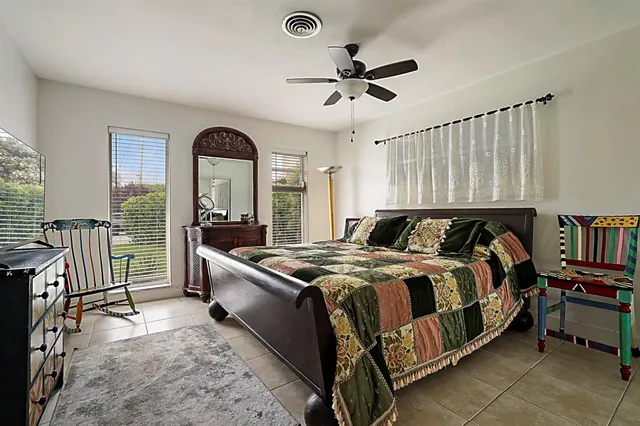 a bedroom with a bed and a window