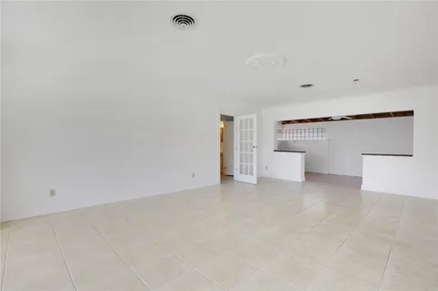 a view of a big room with windows and chandelier