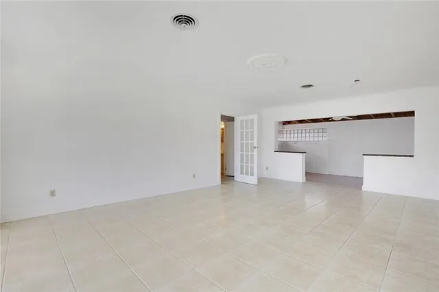 a view of a big room with windows and chandelier