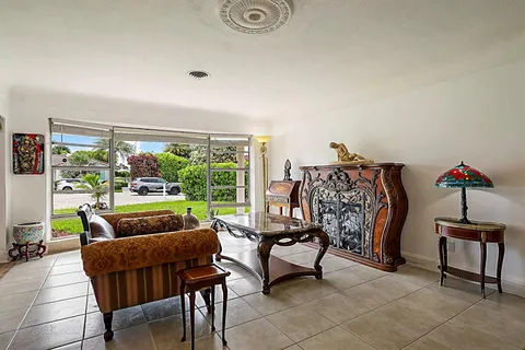 a dining room with furniture and a chandelier