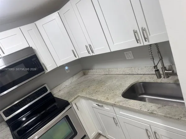 a kitchen with a sink and cabinets