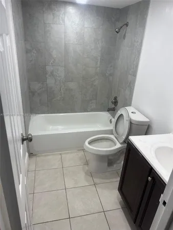 a bathroom with a toilet a sink and bathtub