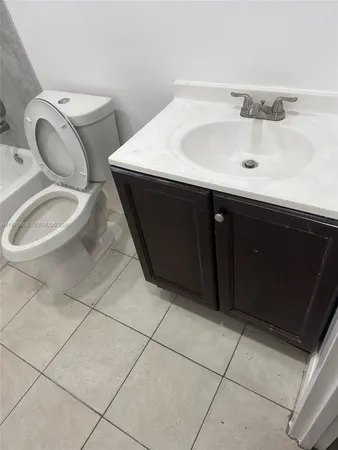 a bathroom with a sink toilet and mirror