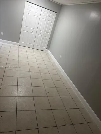 a view of an empty room and a window