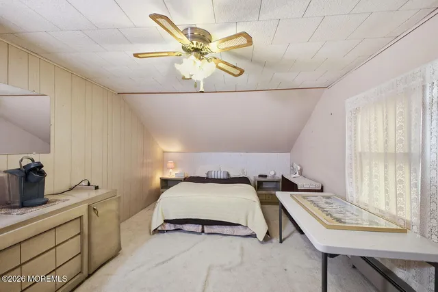 a bedroom with a bed and ceiling fan