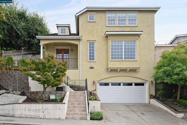a front view of a house with trees