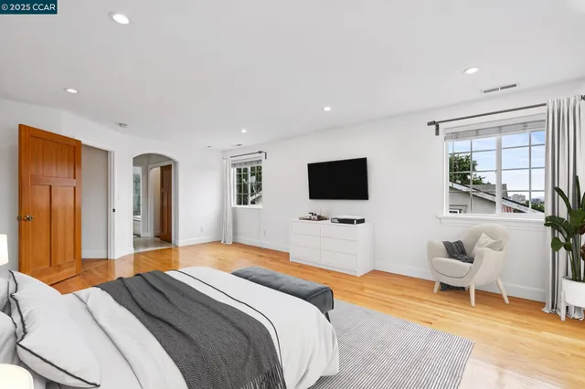 a bedroom with a bed and a flat screen tv