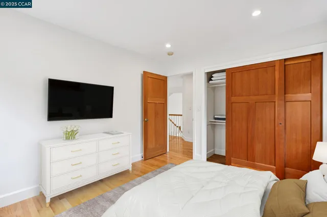 a bedroom with a bed and flat screen tv