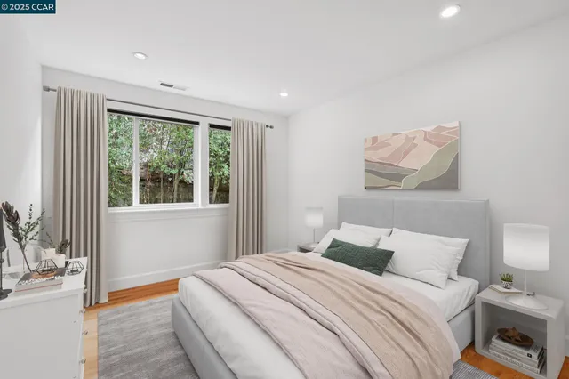 a bedroom with a bed and a large window