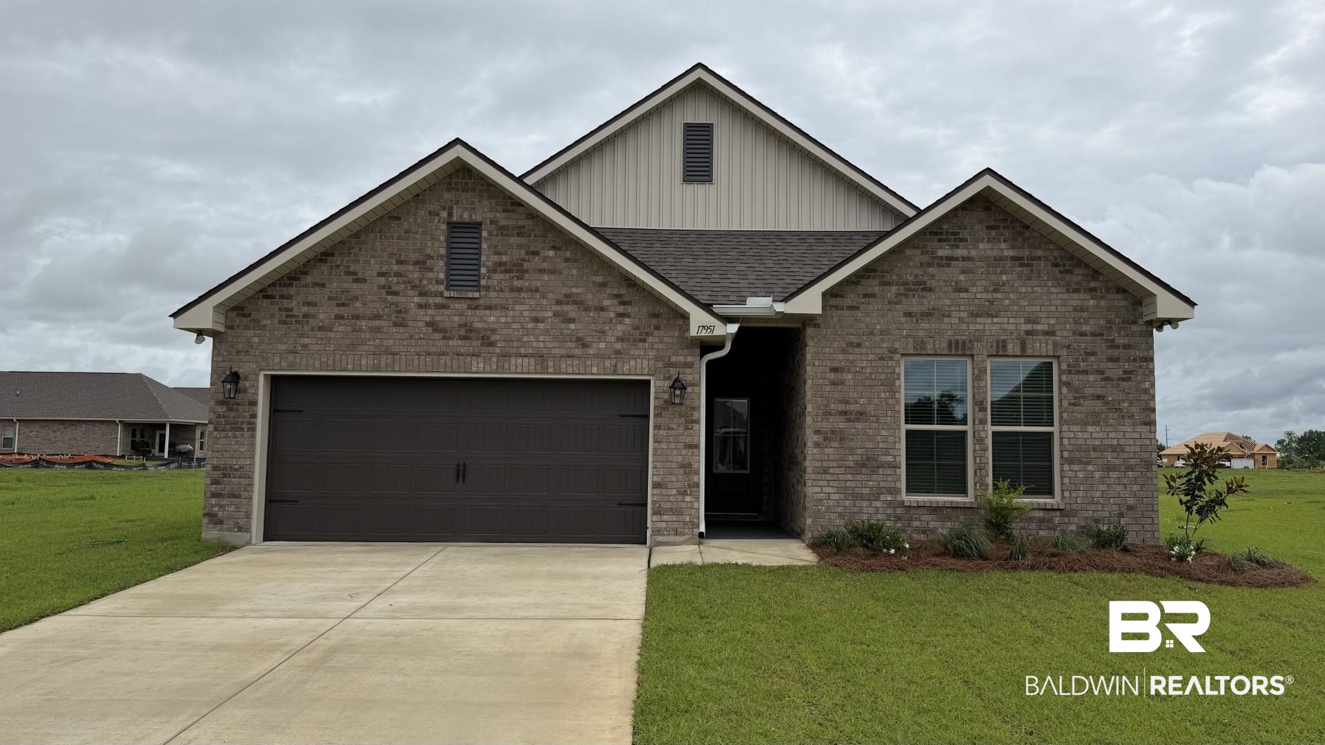 17951 Piney Circle Foley, AL 36535 - Photo 1 of 3 Brick facade home featuring a two-car garage, concrete driveway, and front lawn with minimal landscaping