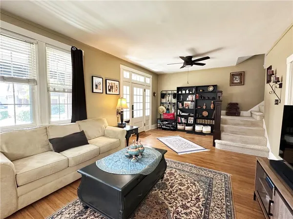 a living room with furniture and a wooden floor