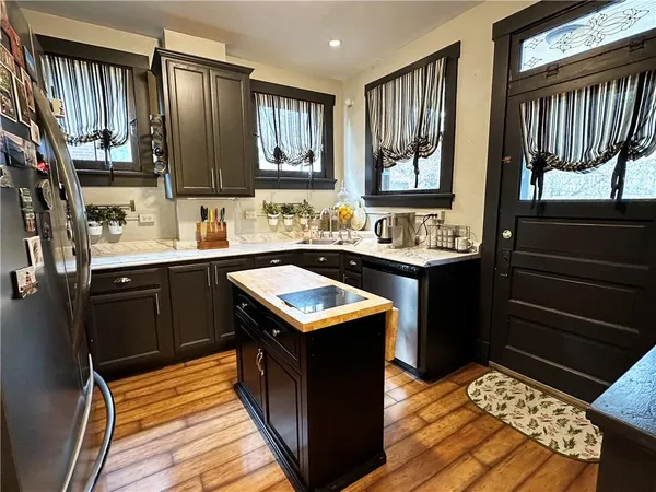 a kitchen with a sink stove and microwave