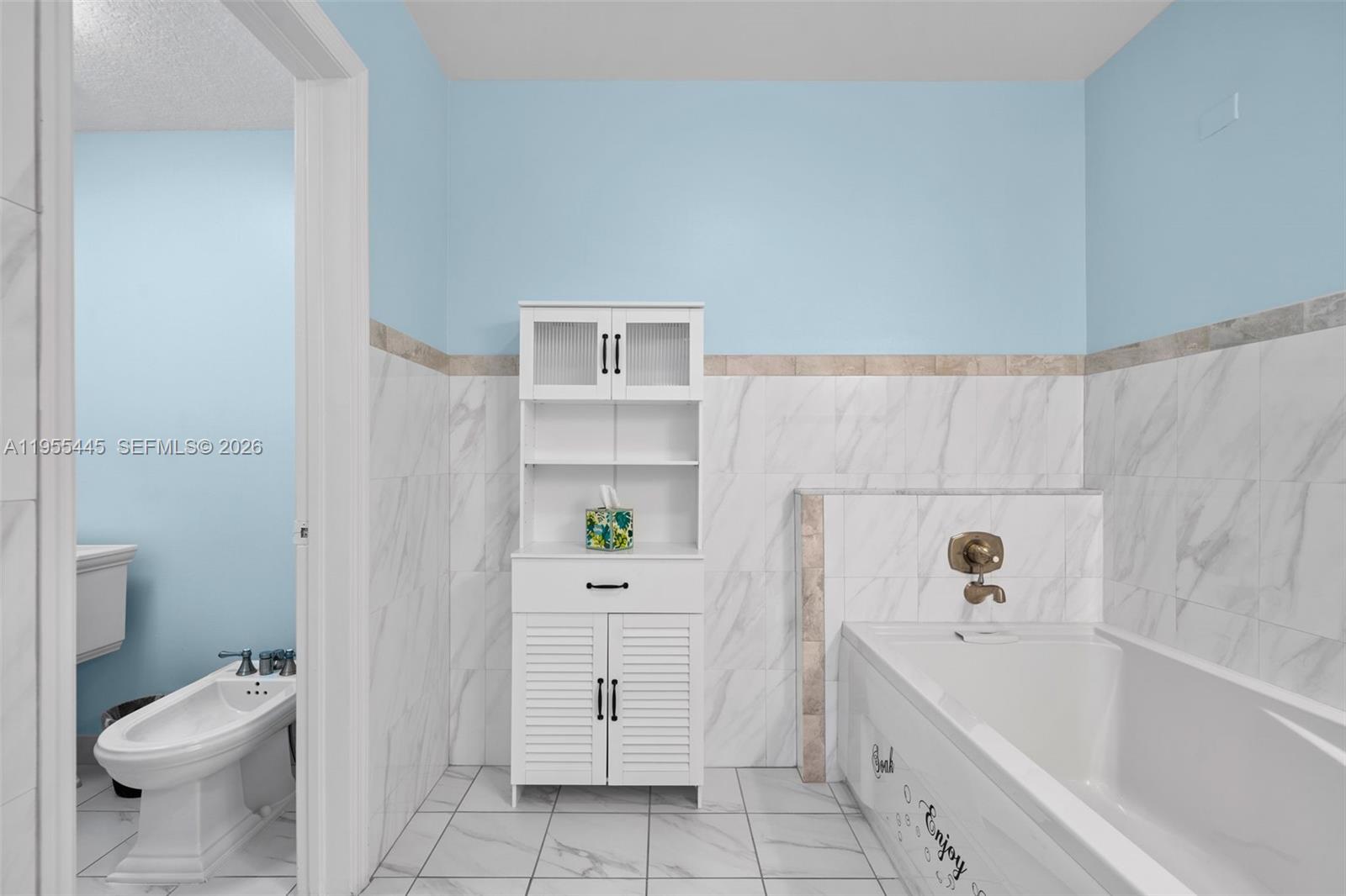 311 North Surf Road Hollywood, FL 33019 - Photo 25 of 61 a bathroom with a sink a toilet and bathtub