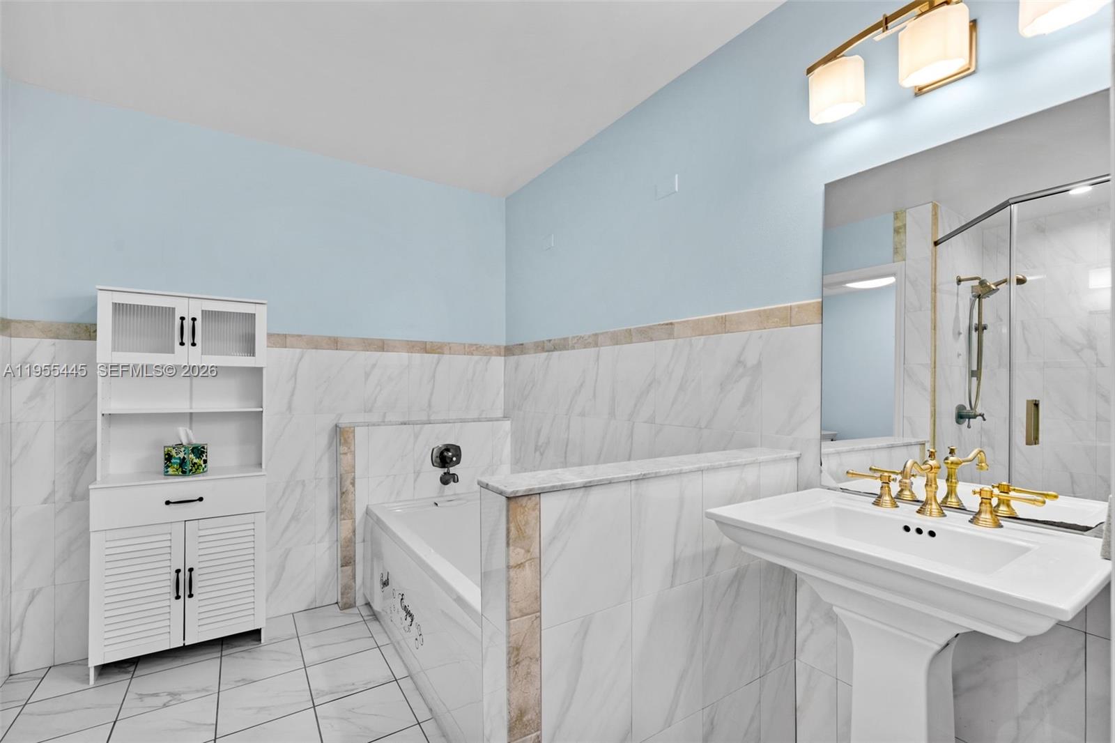 311 North Surf Road Hollywood, FL 33019 - Photo 26 of 61 a bathroom with a sink a toilet and shower