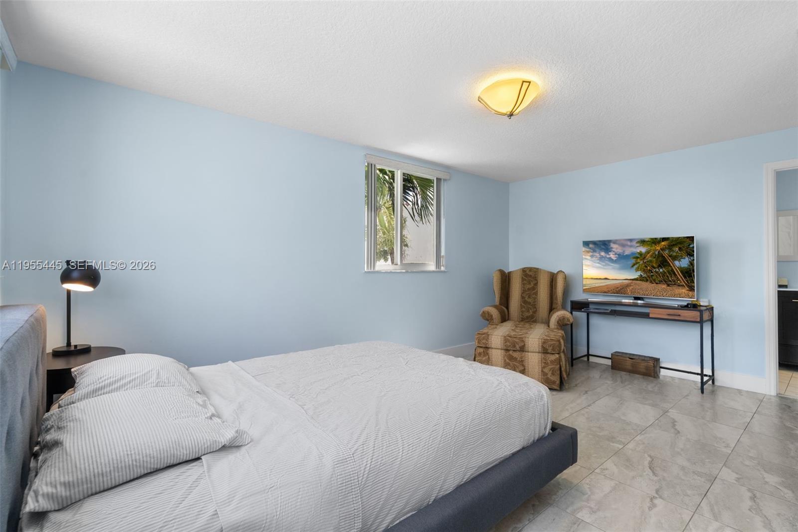 311 North Surf Road Hollywood, FL 33019 - Photo 27 of 61 a bedroom with a bed and a desk