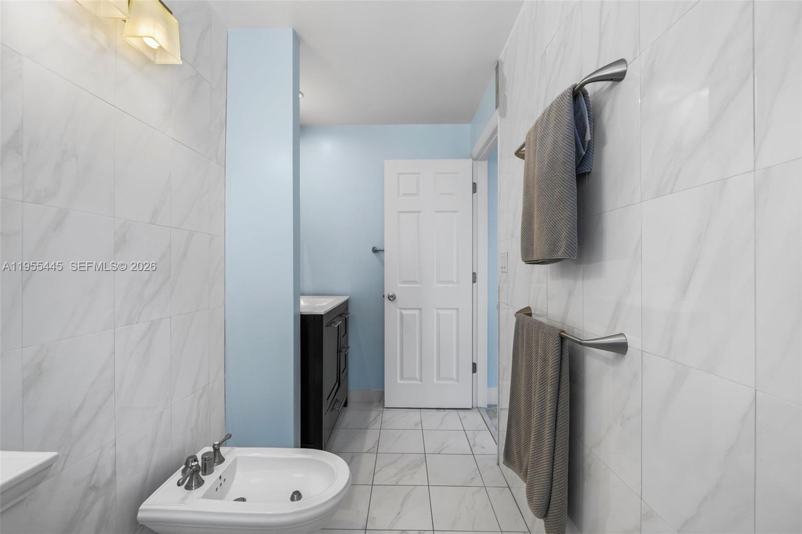 311 North Surf Road Hollywood, FL 33019 - Photo 29 of 61 a bathroom with a sink and a mirror