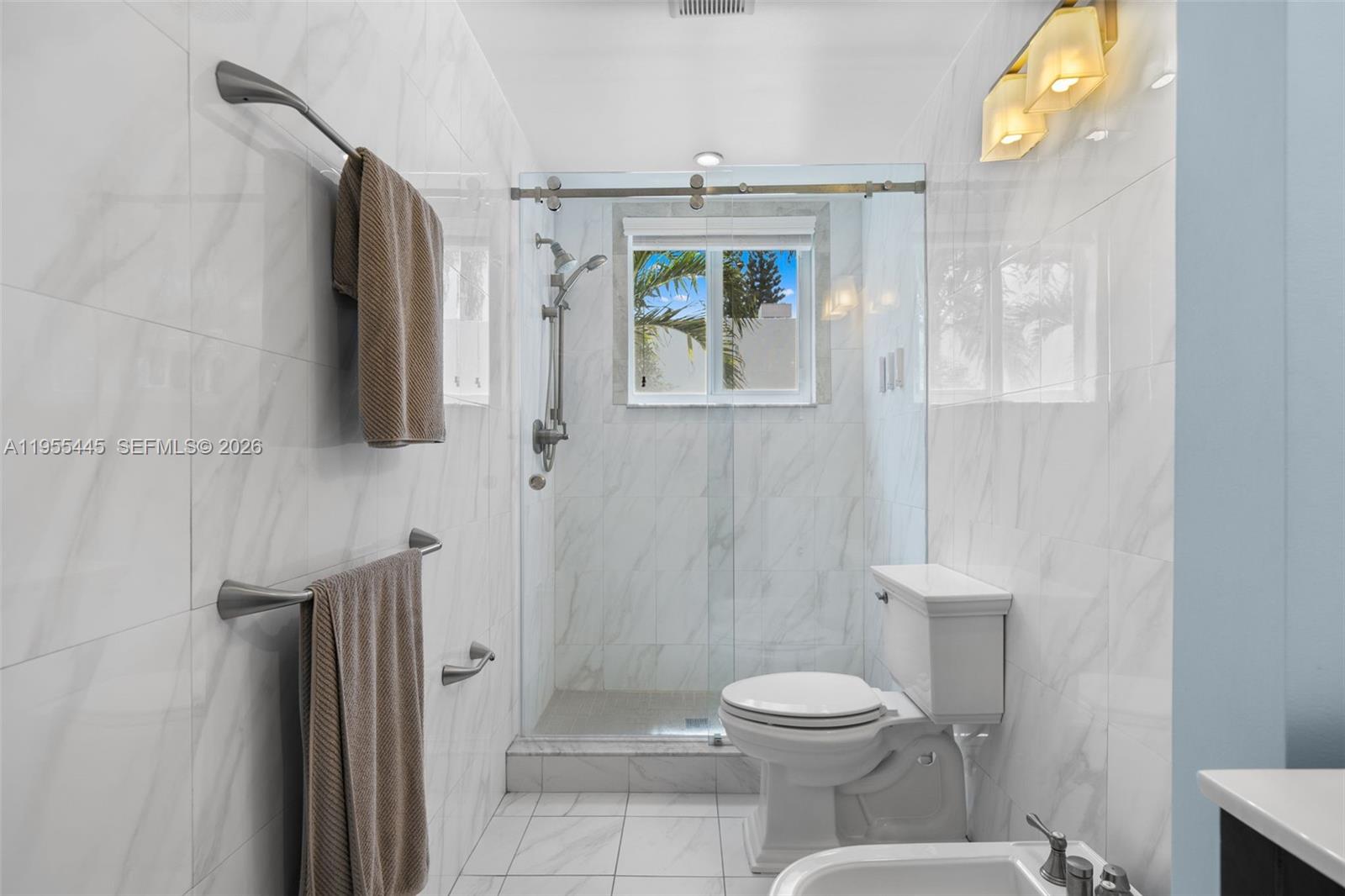 311 North Surf Road Hollywood, FL 33019 - Photo 30 of 61 a bathroom with a toilet and a shower