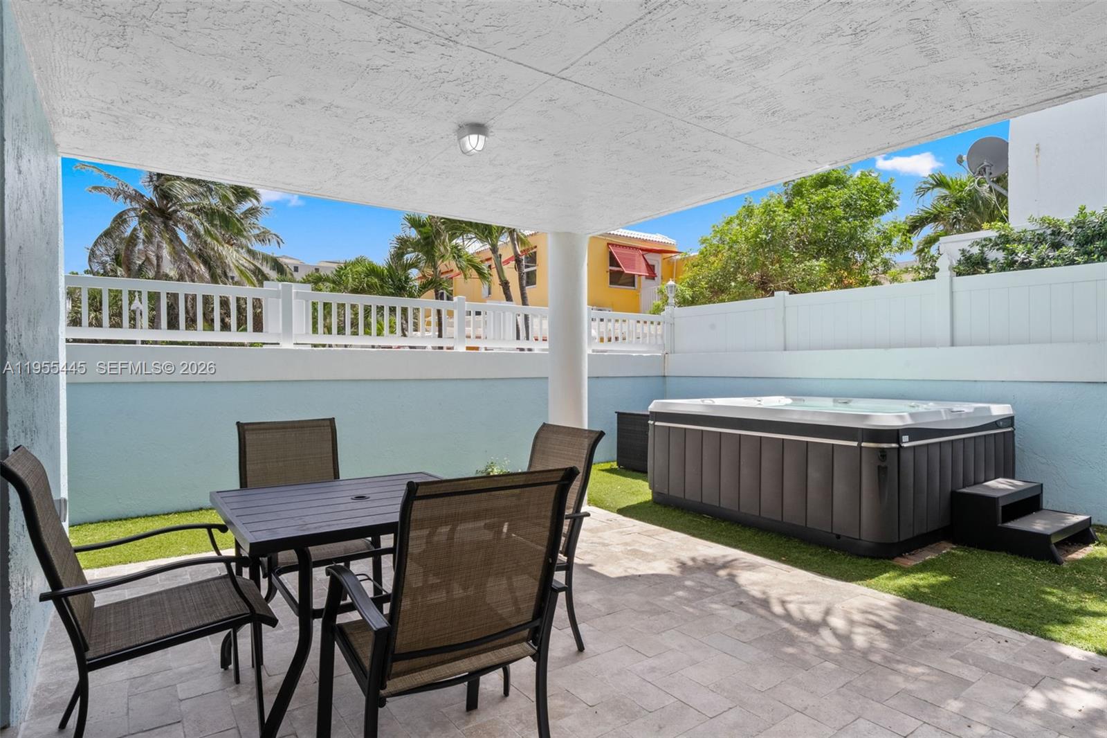 311 North Surf Road Hollywood, FL 33019 - Photo 45 of 61 a view of a patio with table and chairs with wooden fence and plants