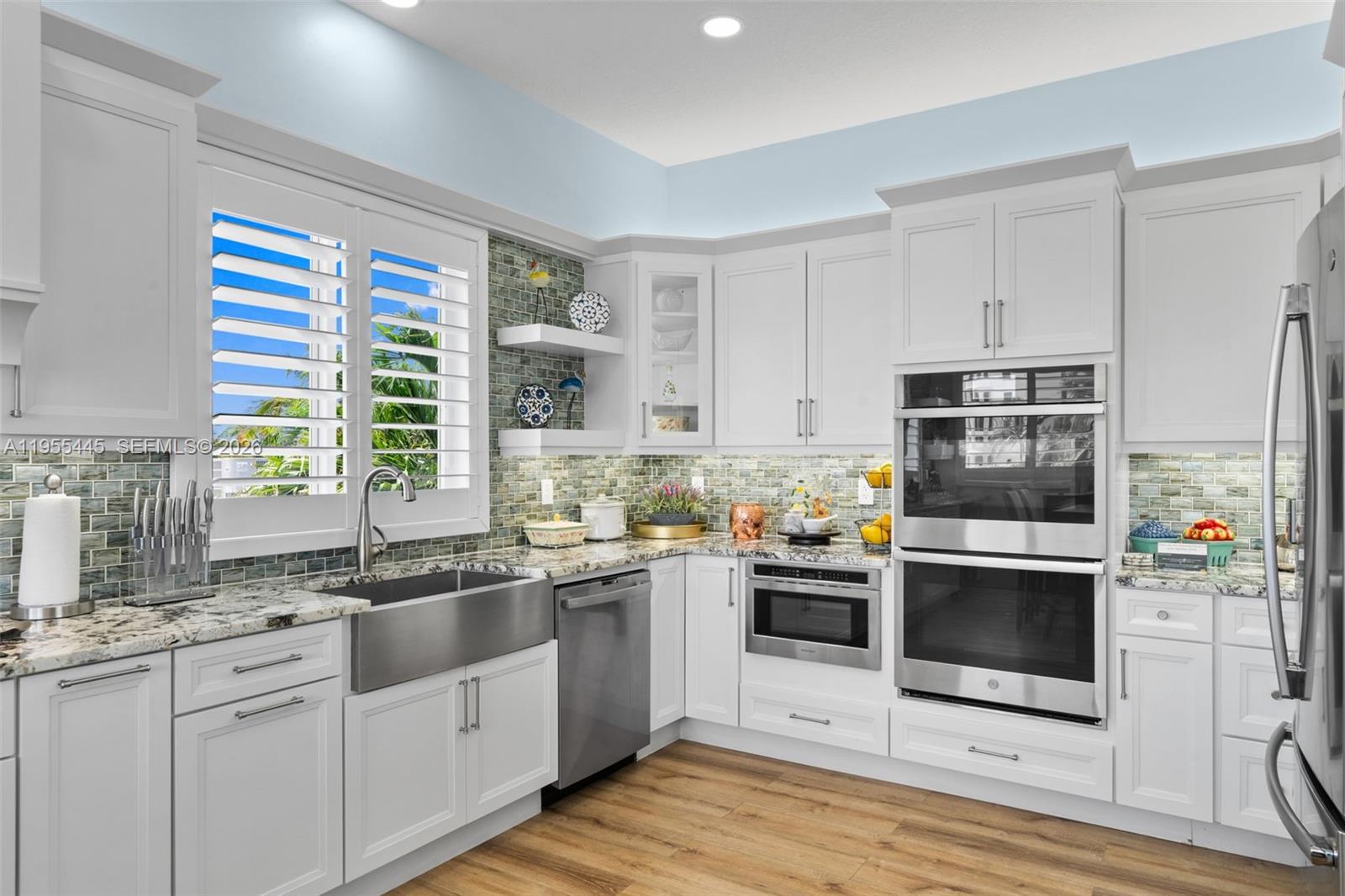 311 North Surf Road Hollywood, FL 33019 - Photo 6 of 61 a kitchen with stainless steel appliances a stove a sink and a microwave