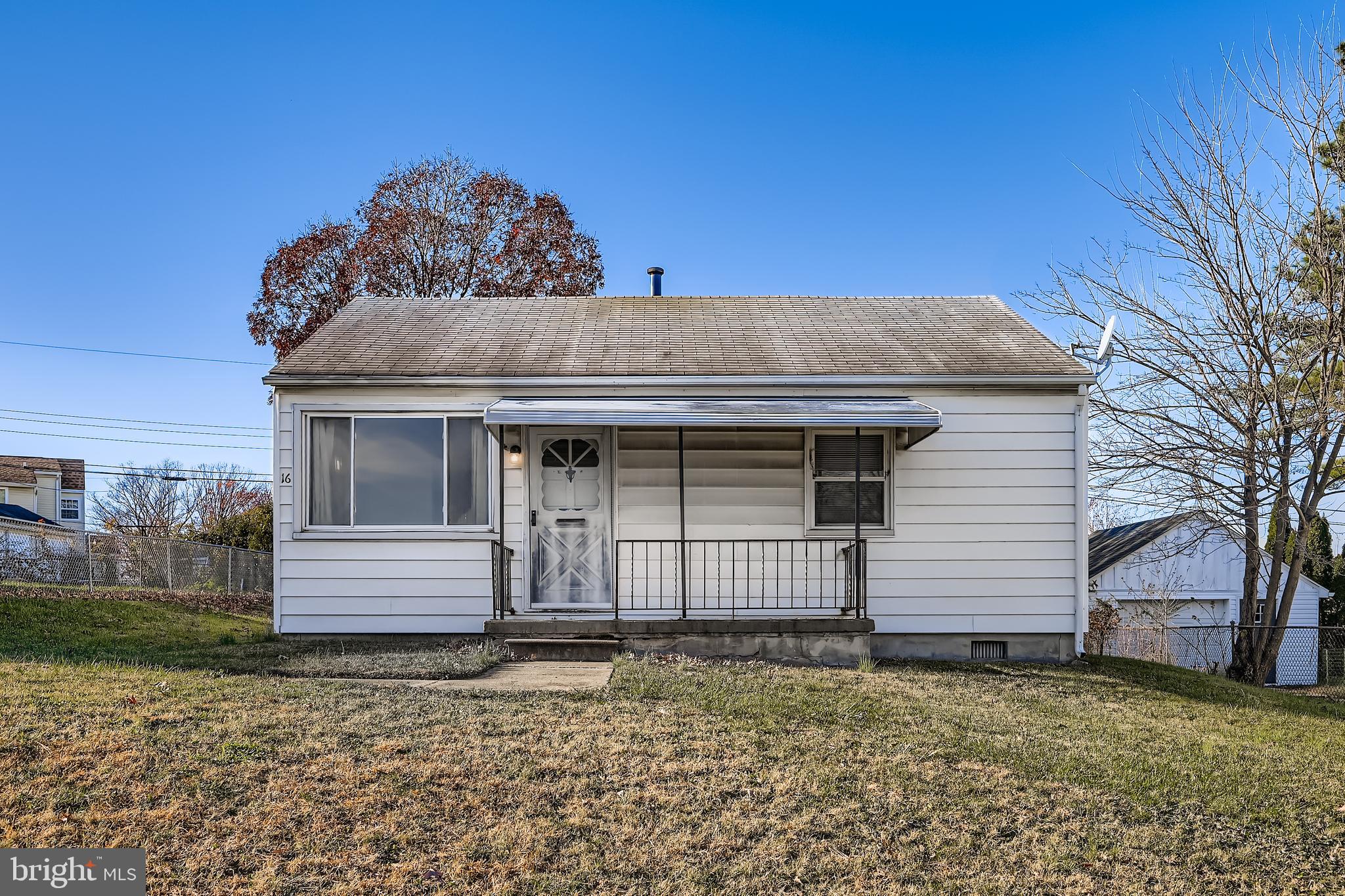 a view of a house with a backyard and a tree