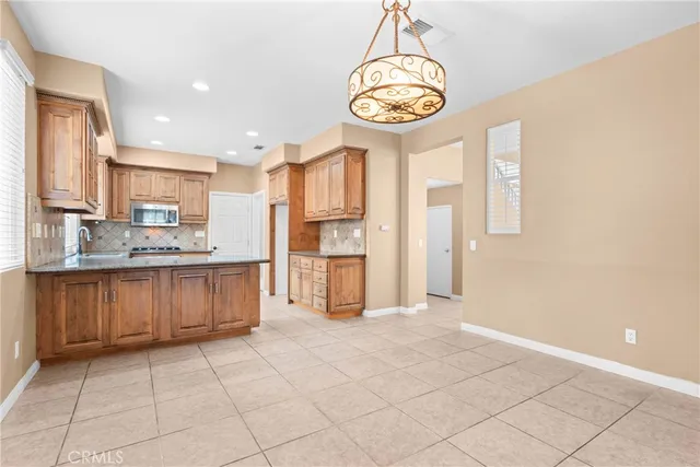 a view of a kitchen with a sink and cabinets