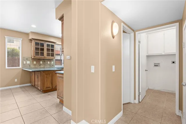 a view of kitchen with granite countertop cabinets and window