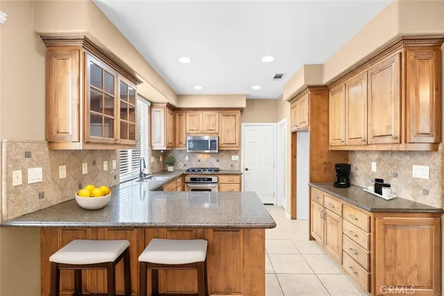a kitchen with a sink appliances and cabinets