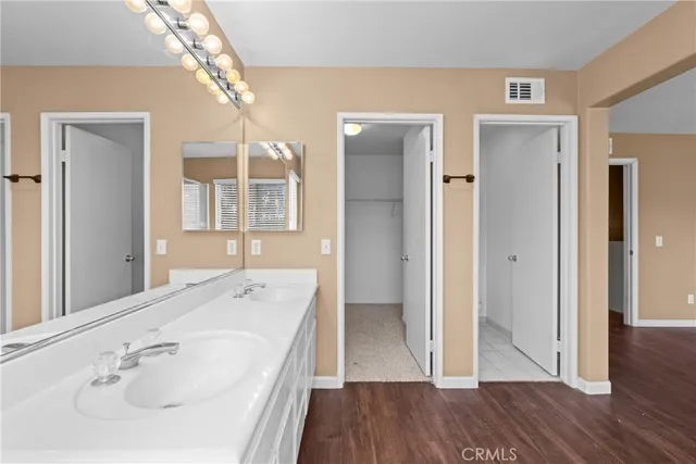 a bathroom with a sink a mirror and a shower