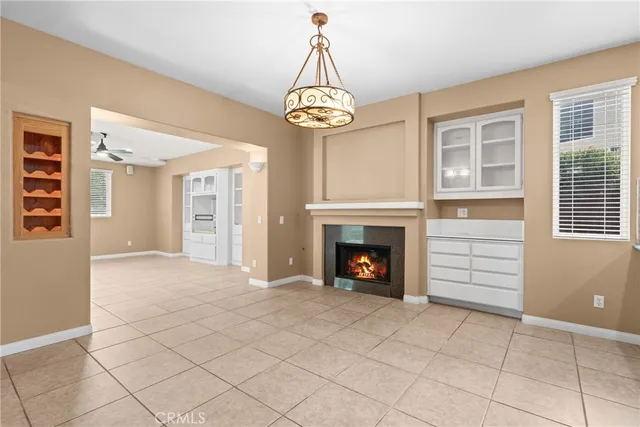 a view of an empty room with a fireplace and a window