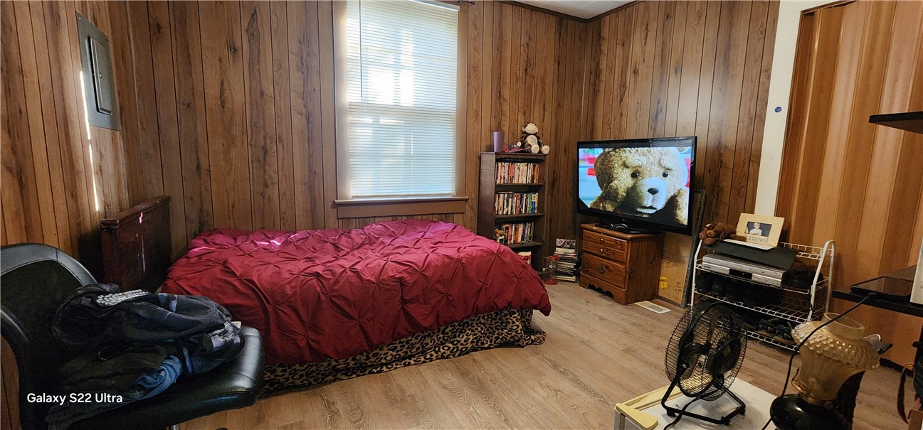 105 Hope Avenue Seneca, SC 29678 - Photo 18 of 33 A well-lit bedroom featuring durable wood paneling and practical flooring.