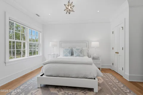 a bedroom with a large bed and a window
