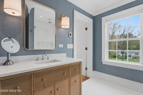 a bathroom with a double vanity sink mirror and double
