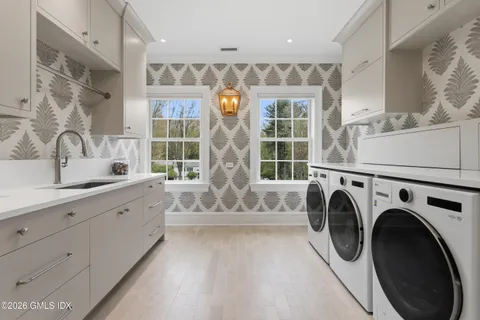 a spacious bathroom with sinks mirror and tub