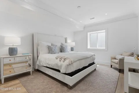 a bedroom with a bed and a dresser in it