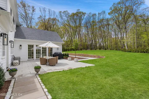a view of a patio with couches fire pit and chairs