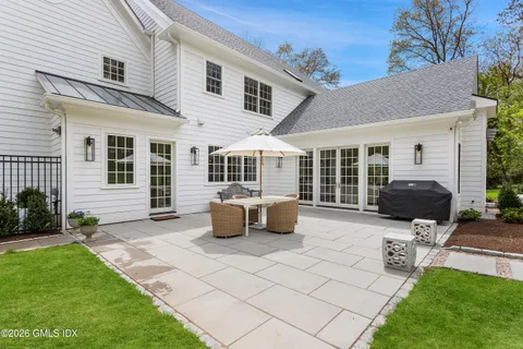 a view of a house with backyard porch and sitting area
