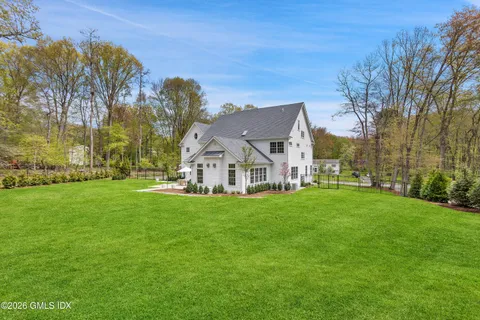 a view of a big yard with a house in the background