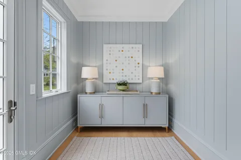a view of cabinets a wooden floor and a window in a room