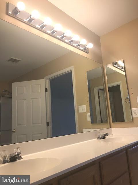 2025 Germander Way Woodbridge, VA 22192 - Photo 19 of 39 a bathroom with a sink and a mirror
