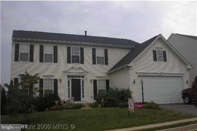 2025 Germander Way Woodbridge, VA 22192 - Photo 2 of 39 a front view of a house with a garden and plants