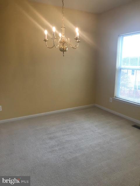 2025 Germander Way Woodbridge, VA 22192 - Photo 28 of 39 en empty room with windows and chandelier