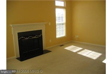 2025 Germander Way Woodbridge, VA 22192 - Photo 7 of 39 a living room with a fireplace and a window